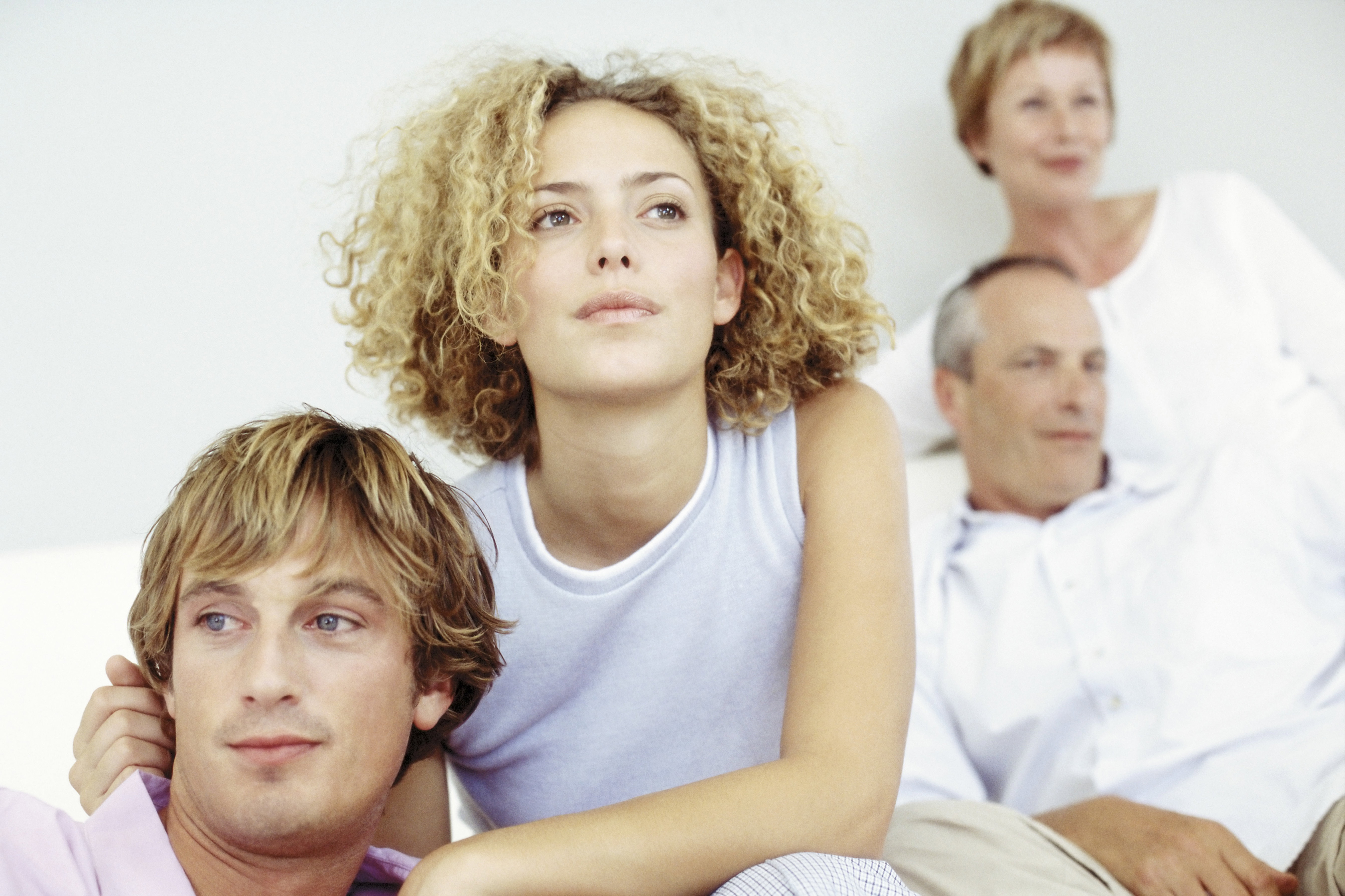 Young couple with in-laws in the background