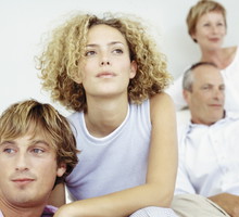 Young couple with in-laws in the background