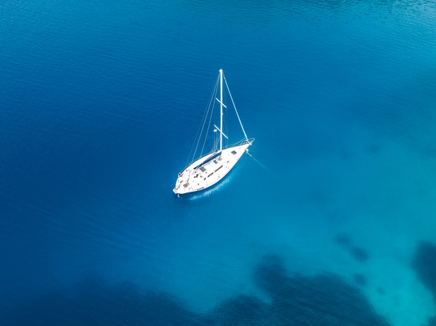 Aerial image showing a yacht moored on the ocean, Himarë, Vlorë, Albania