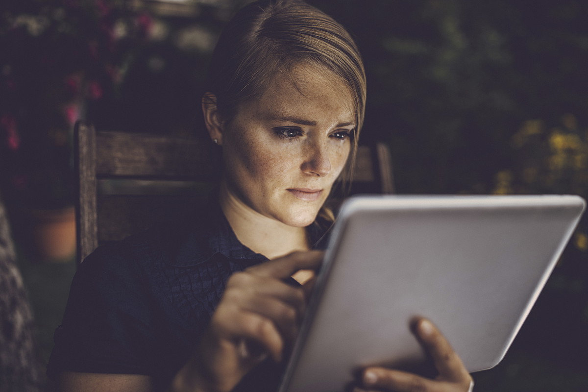 Woman using tablet outdoor.