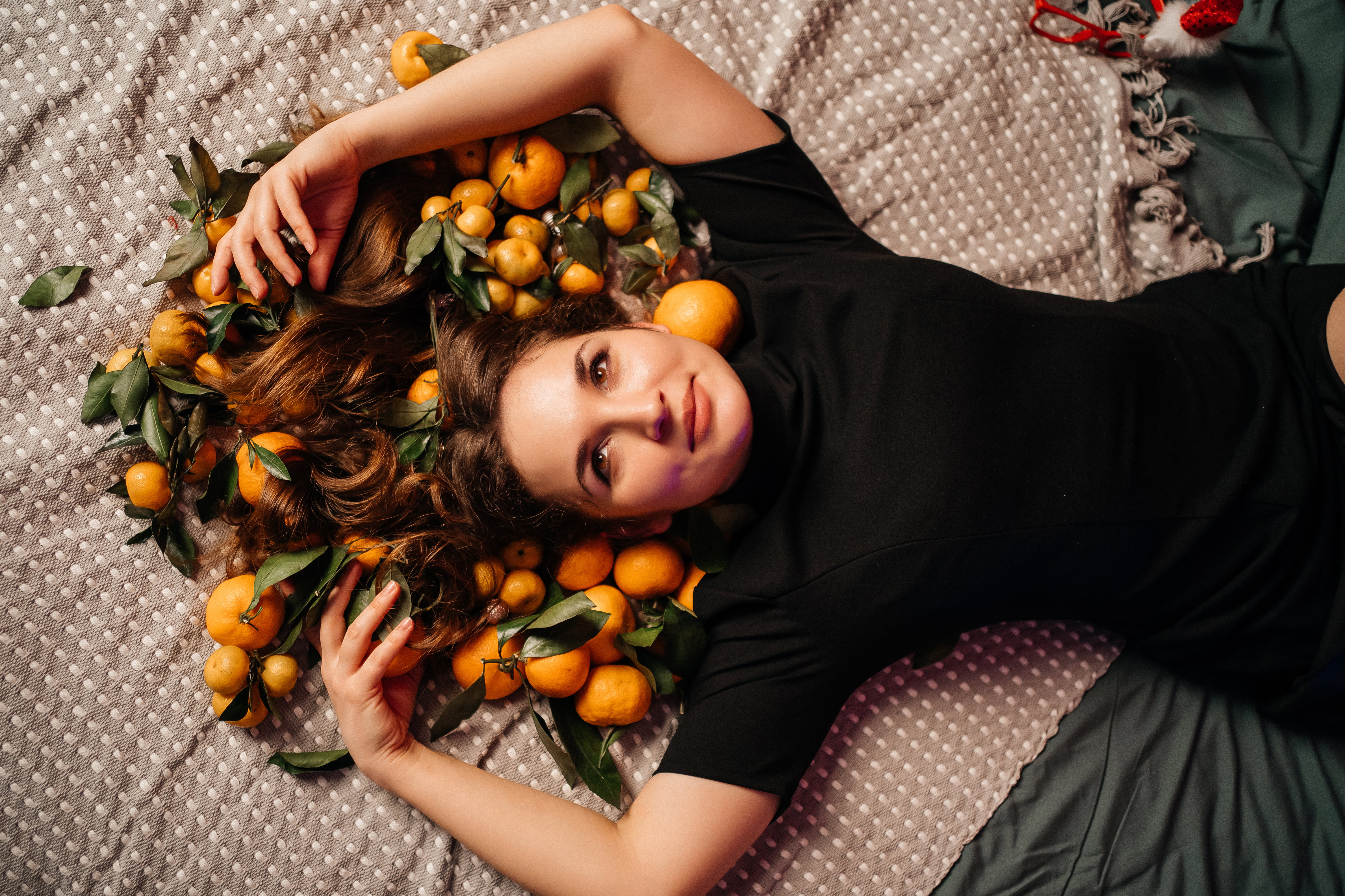girl on the bed in tangerines for the new year