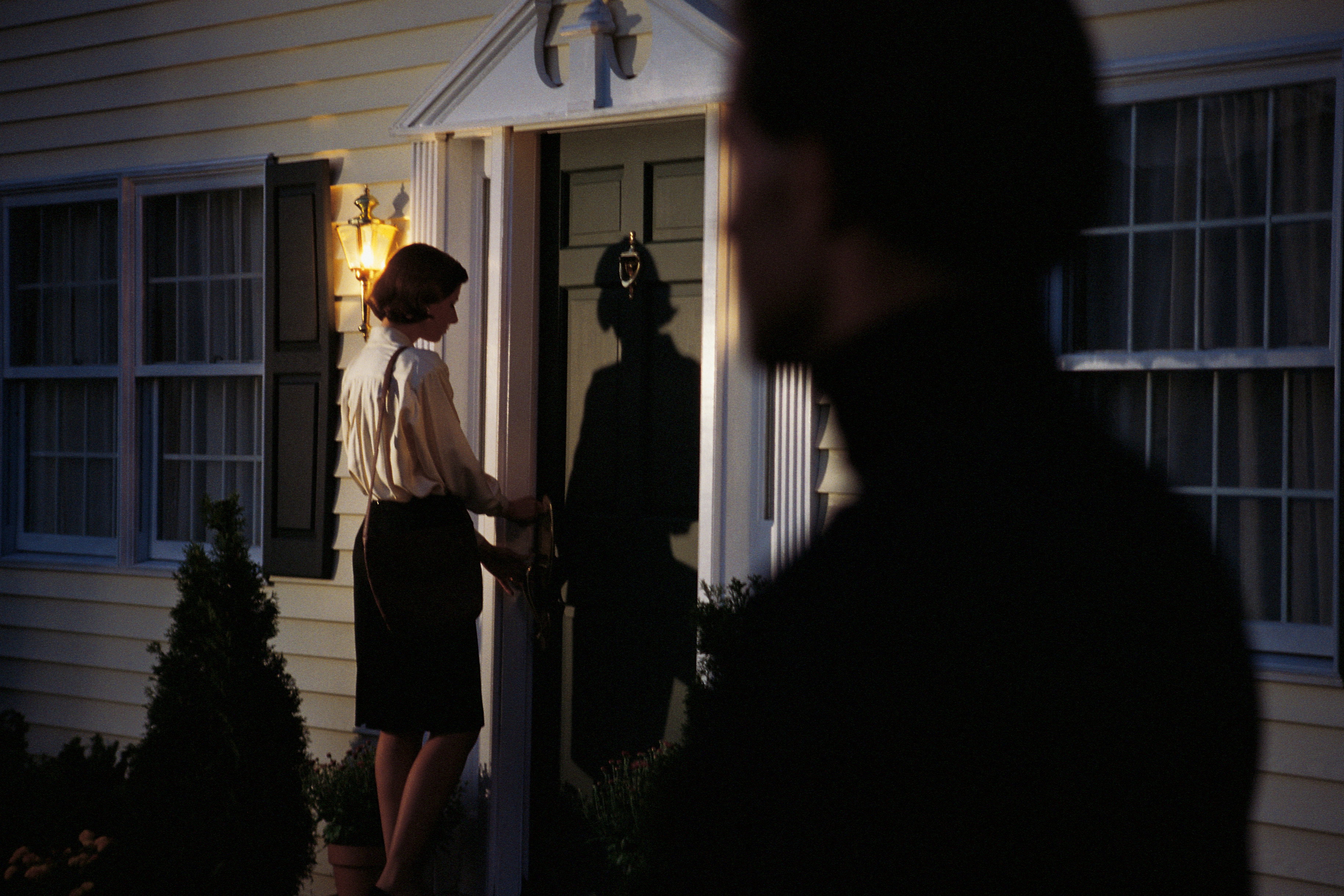 Stalker spying on woman at front door