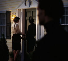 Stalker spying on woman at front door