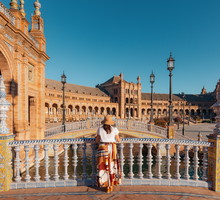 A woman traveler admires the beautiful Plaza de Espana in Seville
