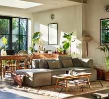 Open plan living space in residential house with natural light and retro furniture