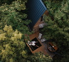 drone view of a couple in a wooden cabin