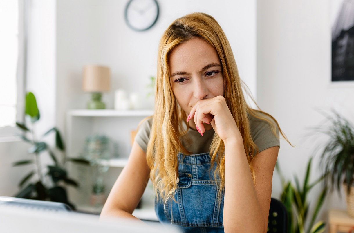 zamyślona kobieta przy biurku