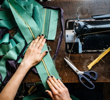 Hands of a woman sewing fabrics