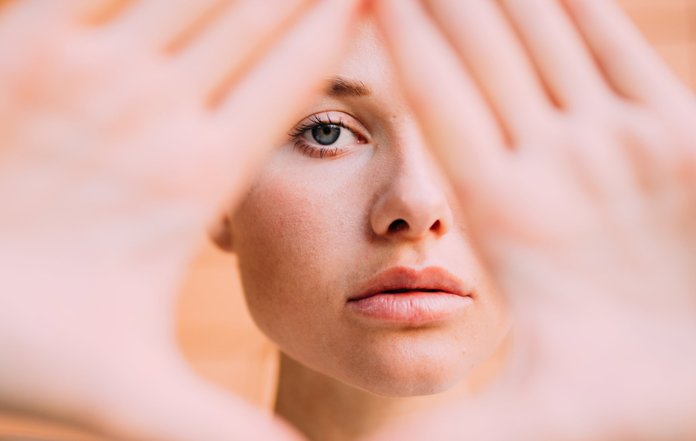 Portrait Of Young Woman Gesturing Over Face