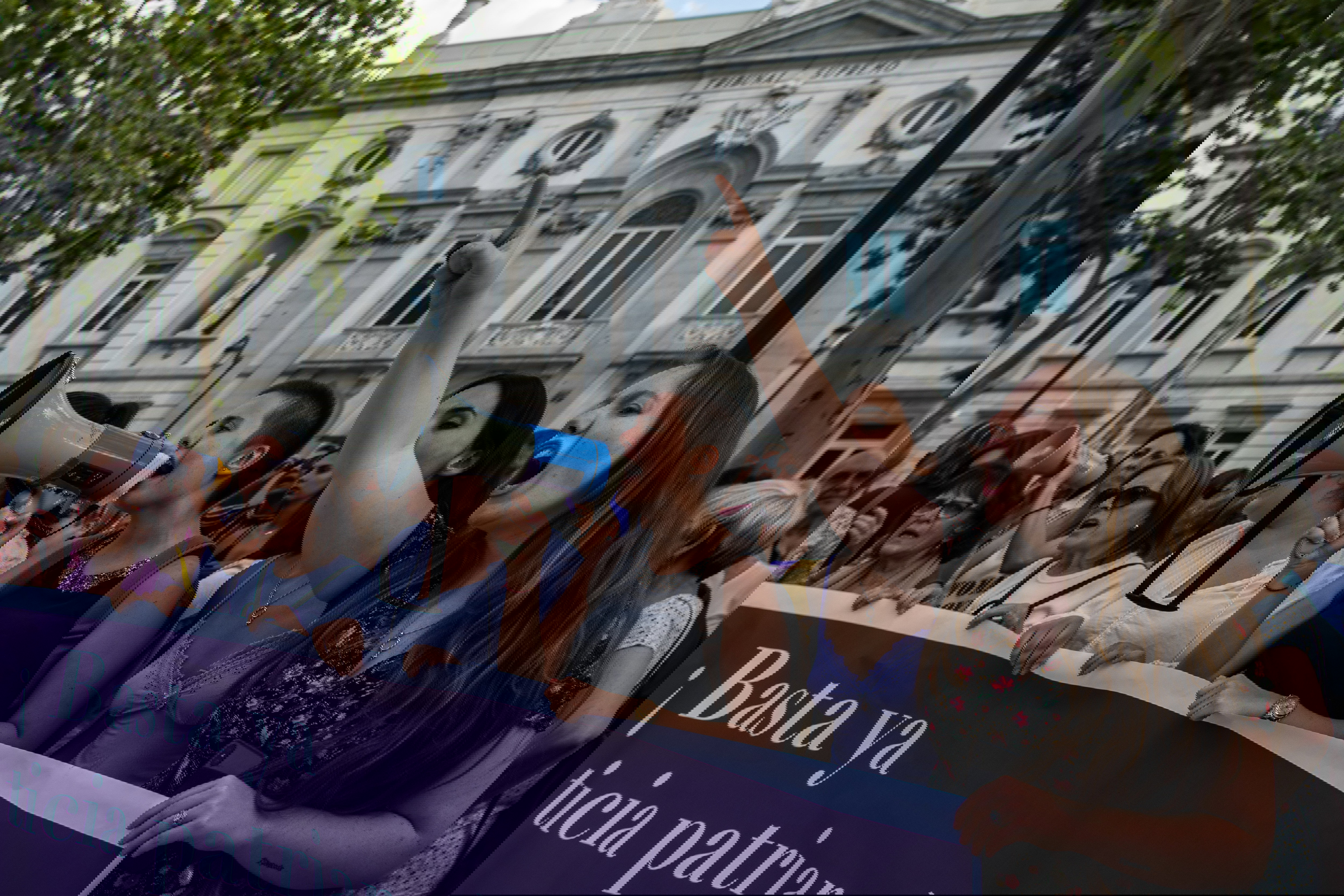 A group of women protesting with a banner reading 'Enough of
