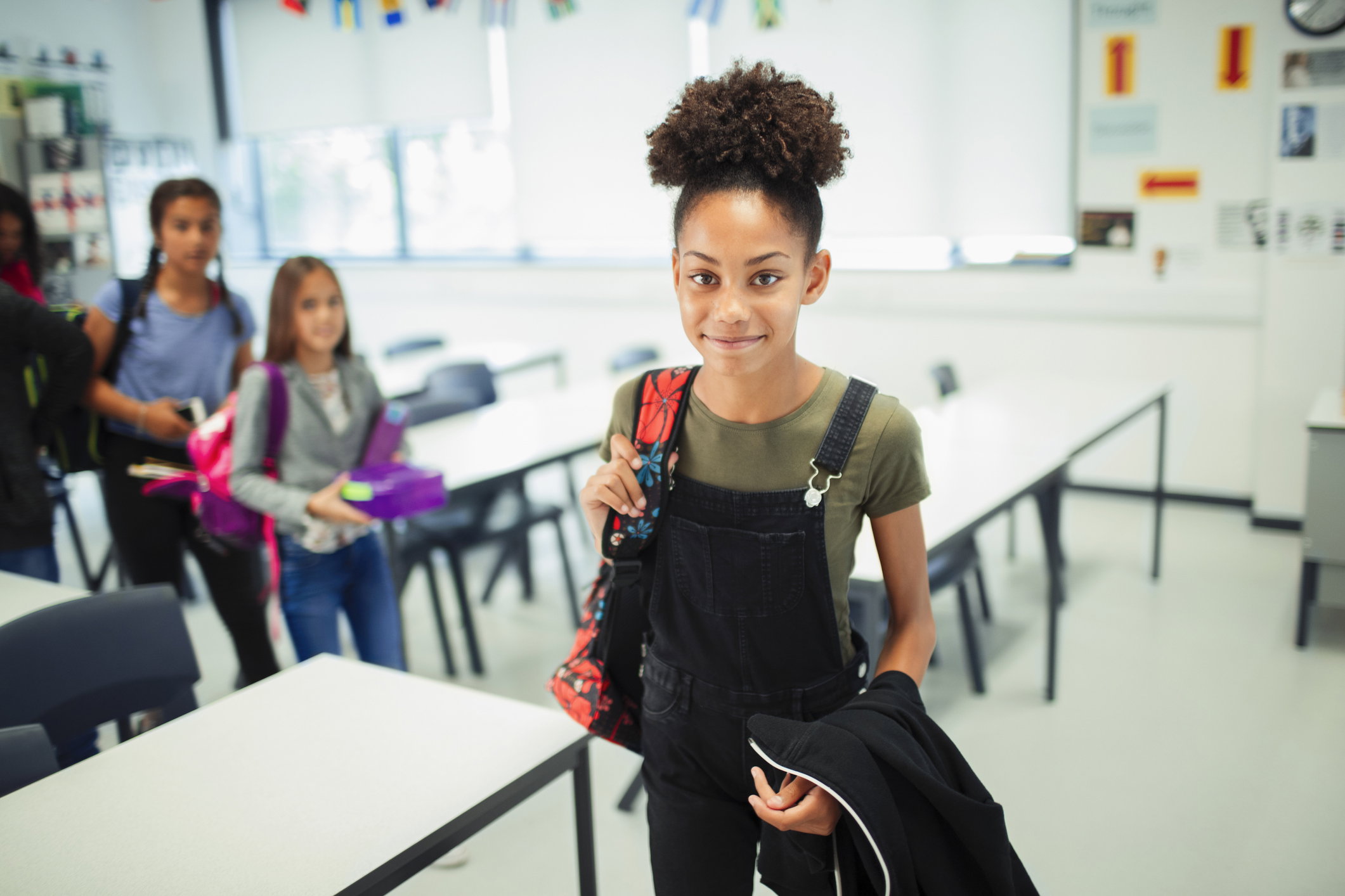 Portrait smiling, confident junior high school girl in classroom