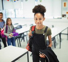 Portrait smiling, confident junior high school girl in classroom