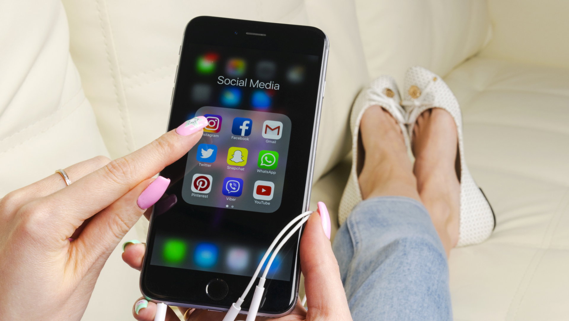 Apple iPhone 7 in woman hand with icons of social media facebook, instagram, twitter, snapchat application on screen. Tablet computer life style. Starting social media app.