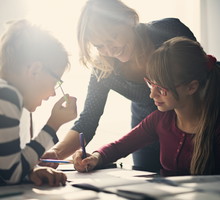 Mother halping kids to do homework