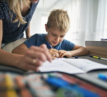 Mother helping son to do his homework