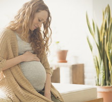 Pregnant woman holding stomach
