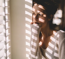 Sad woman looking through the window