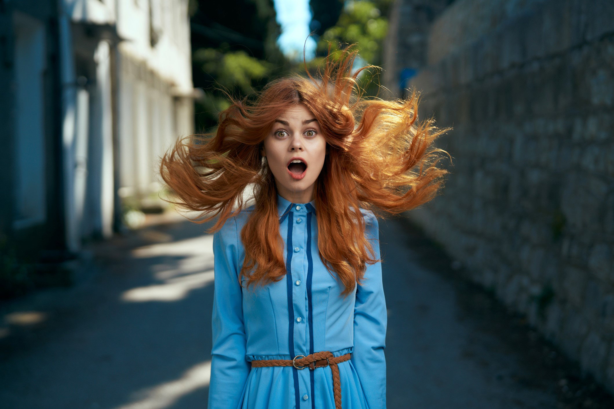Wind blowing hair of surprised Caucasian woman