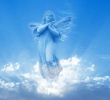 Angel sculpture on blue sky background