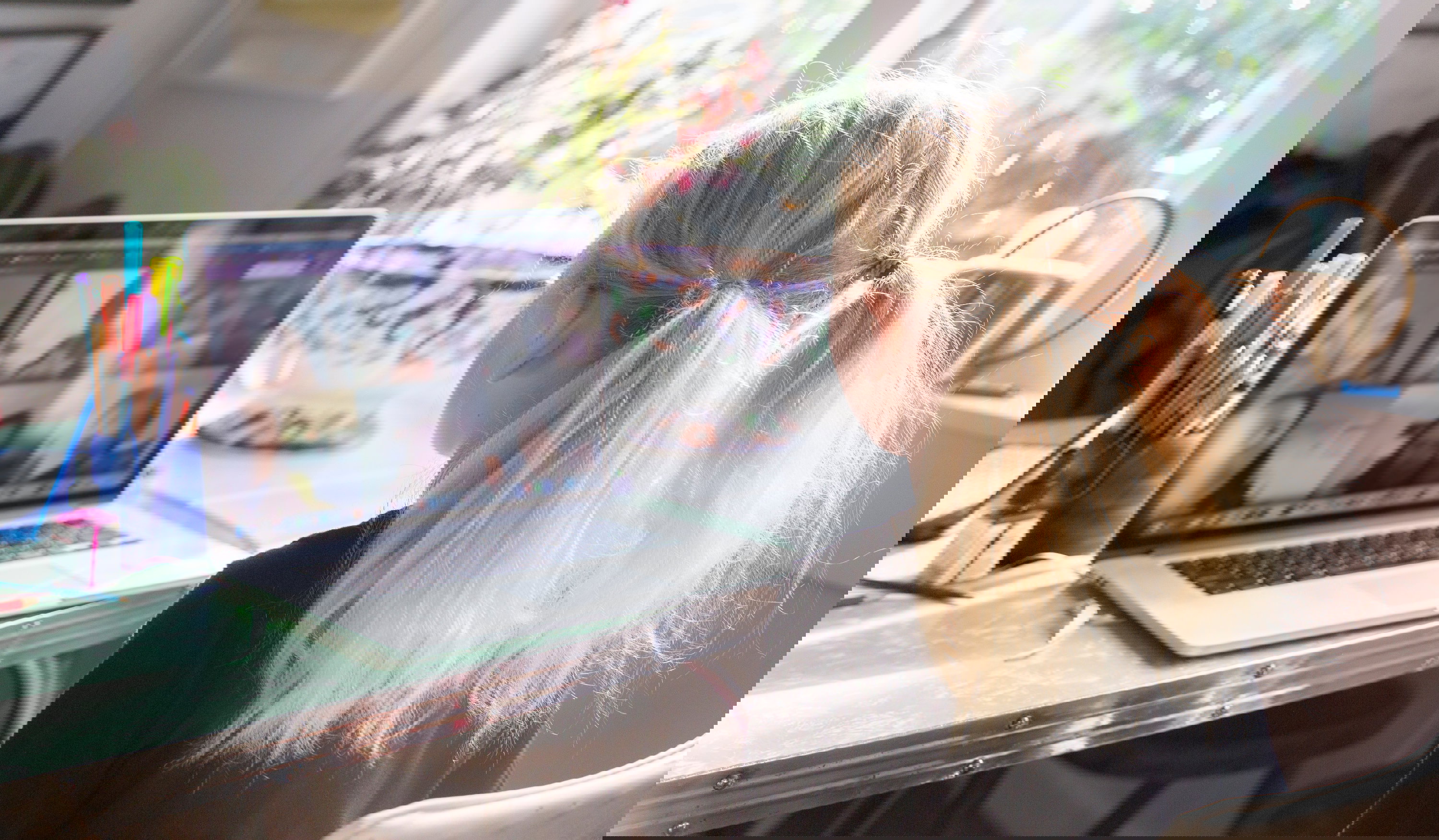 A child talks to her classmates on video conference call