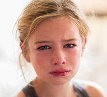 Close up of red face of crying Caucasian girl
