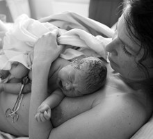 Newborn Baby Lying on Mothers Chest After Birth