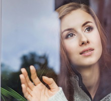 Beautiful young woman on a balcony