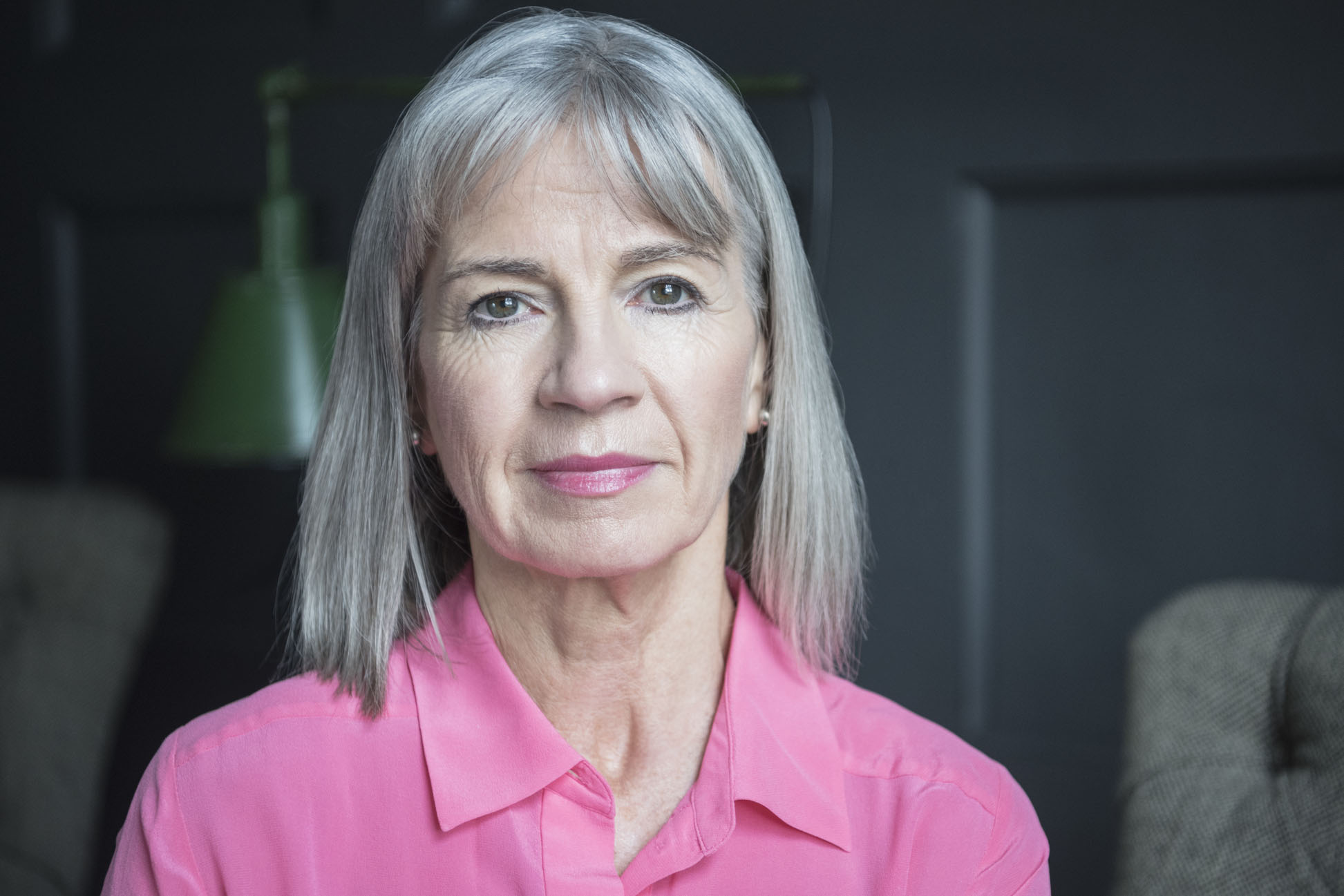 Senior woman with grey bobbed hair looking at camera
