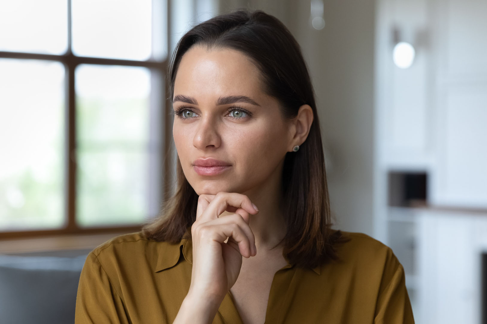 Headshot portrait pensive woman touch chin looking into distance
