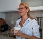 Woman enjoying morning coffee in modern kitchen