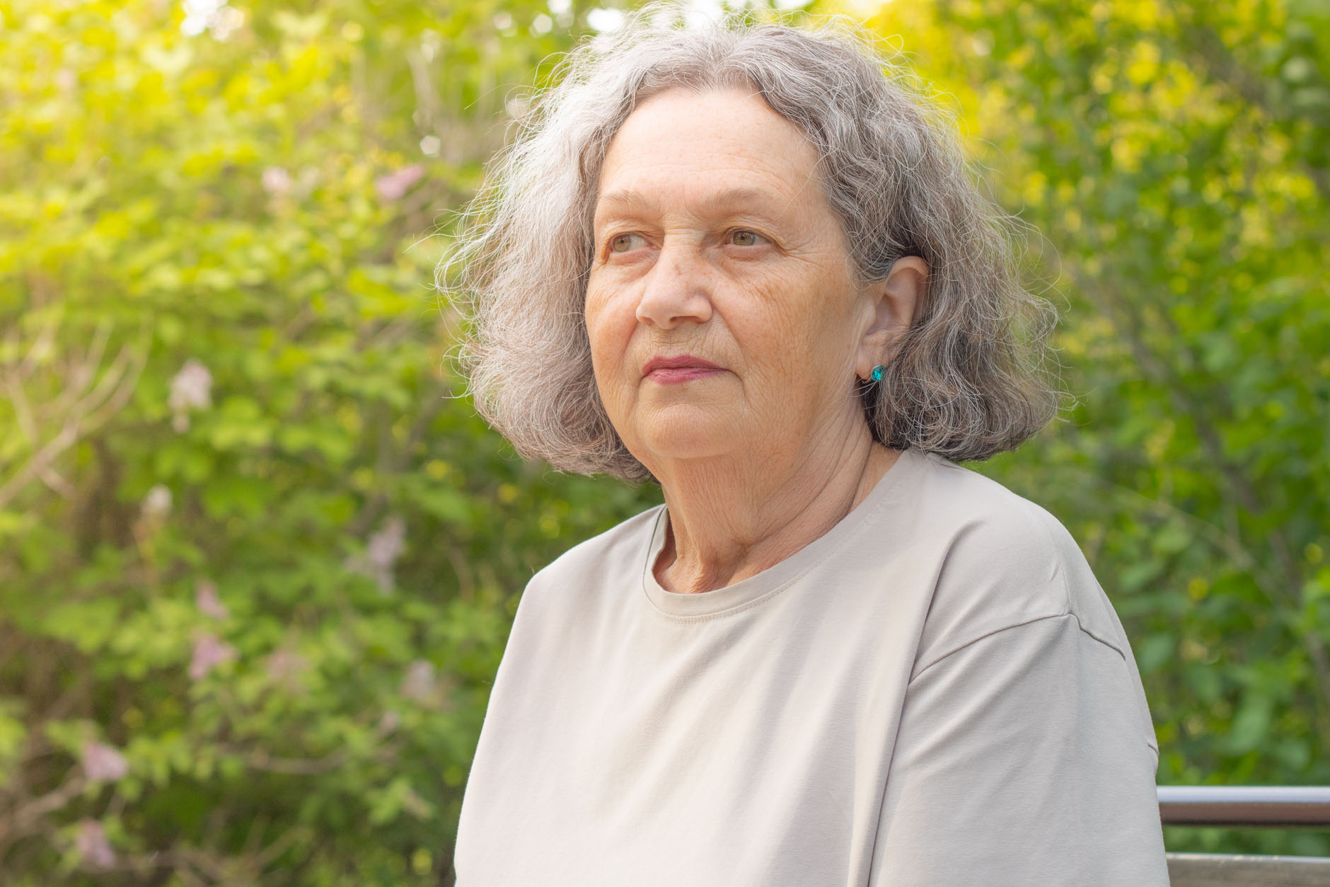 Sad elderly woman reflects on life. Wrinkles on the face, gray hair. Retirement age