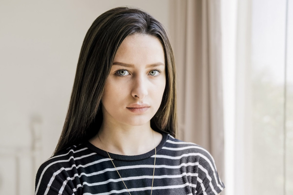 Portrait of thoughtful young woman with blank expression at home