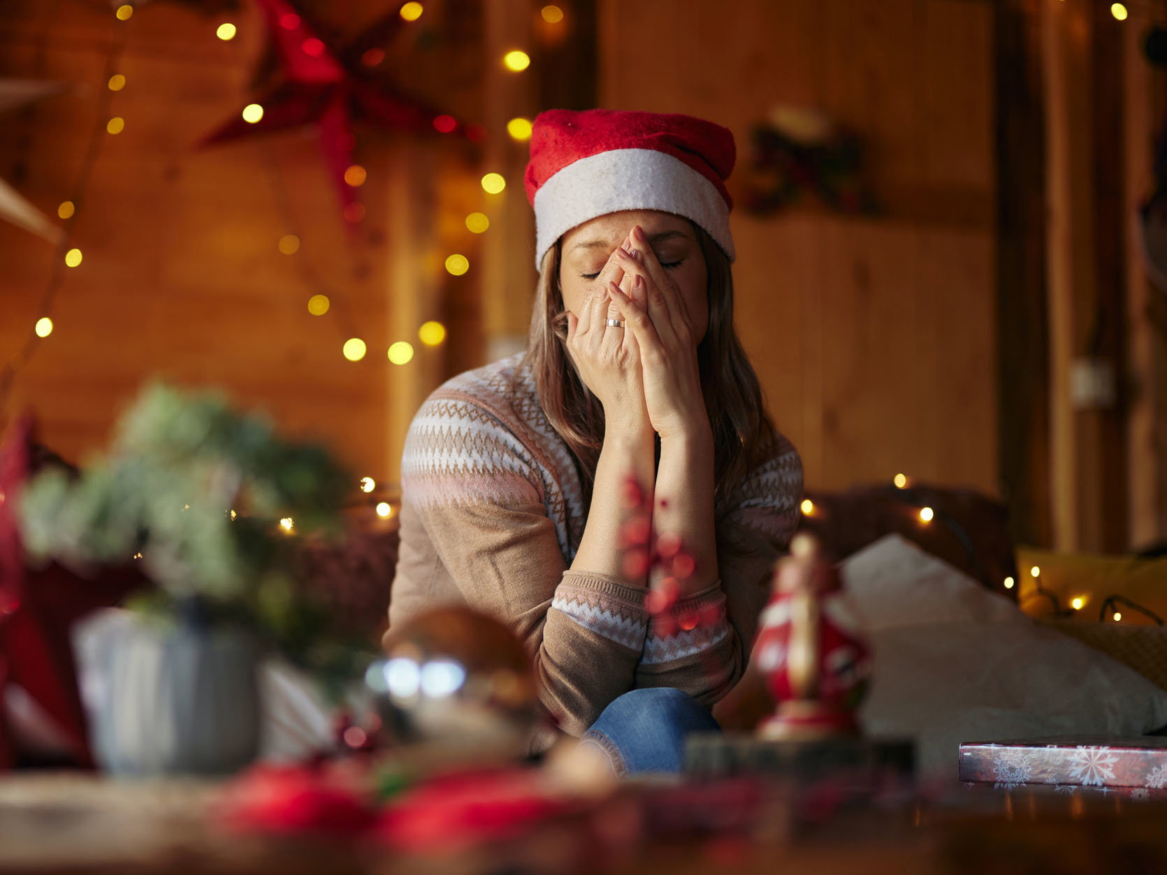 Sad woman feeling lonely on Christmas day at home.