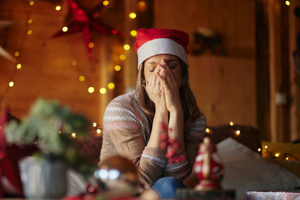 Sad woman feeling lonely on Christmas day at home.
