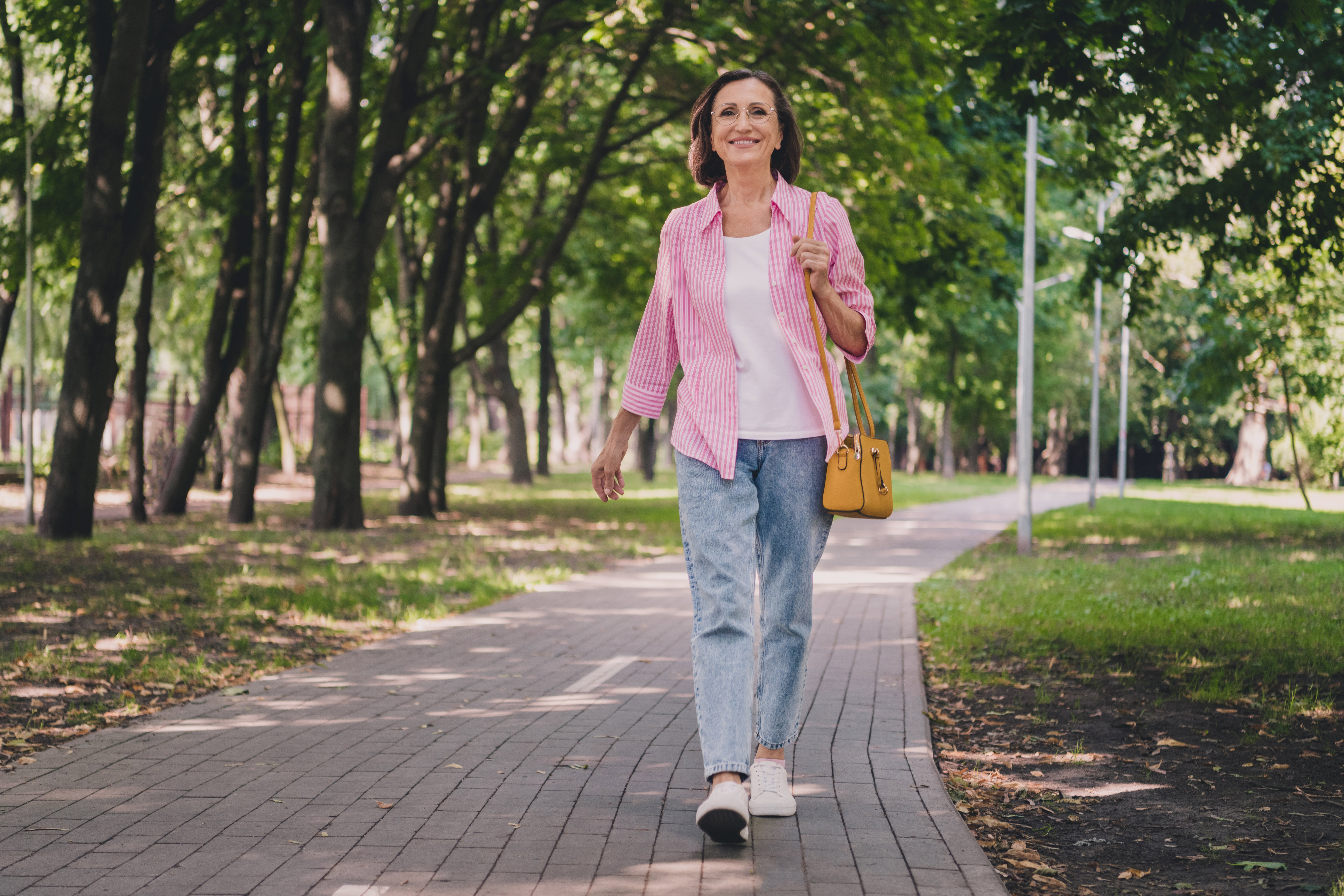 Photo of pretty adorable lady pensioner wear pink shirt walking smiling outdoors countryside garden