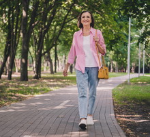 Photo of pretty adorable lady pensioner wear pink shirt walking smiling outdoors countryside garden
