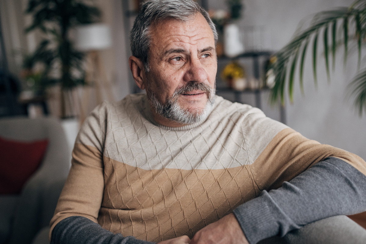Depressed elderly man, alone at home