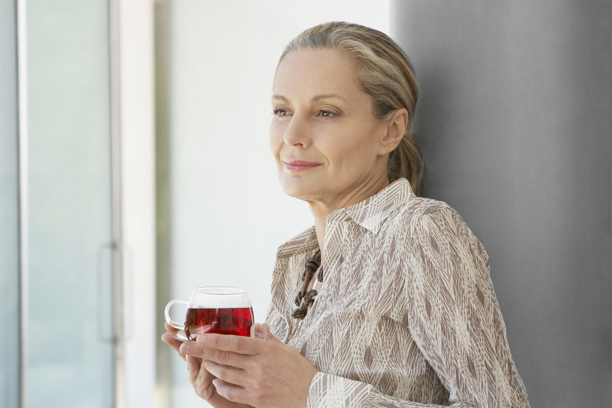 Woman relaxing outdoors with a cup of tea