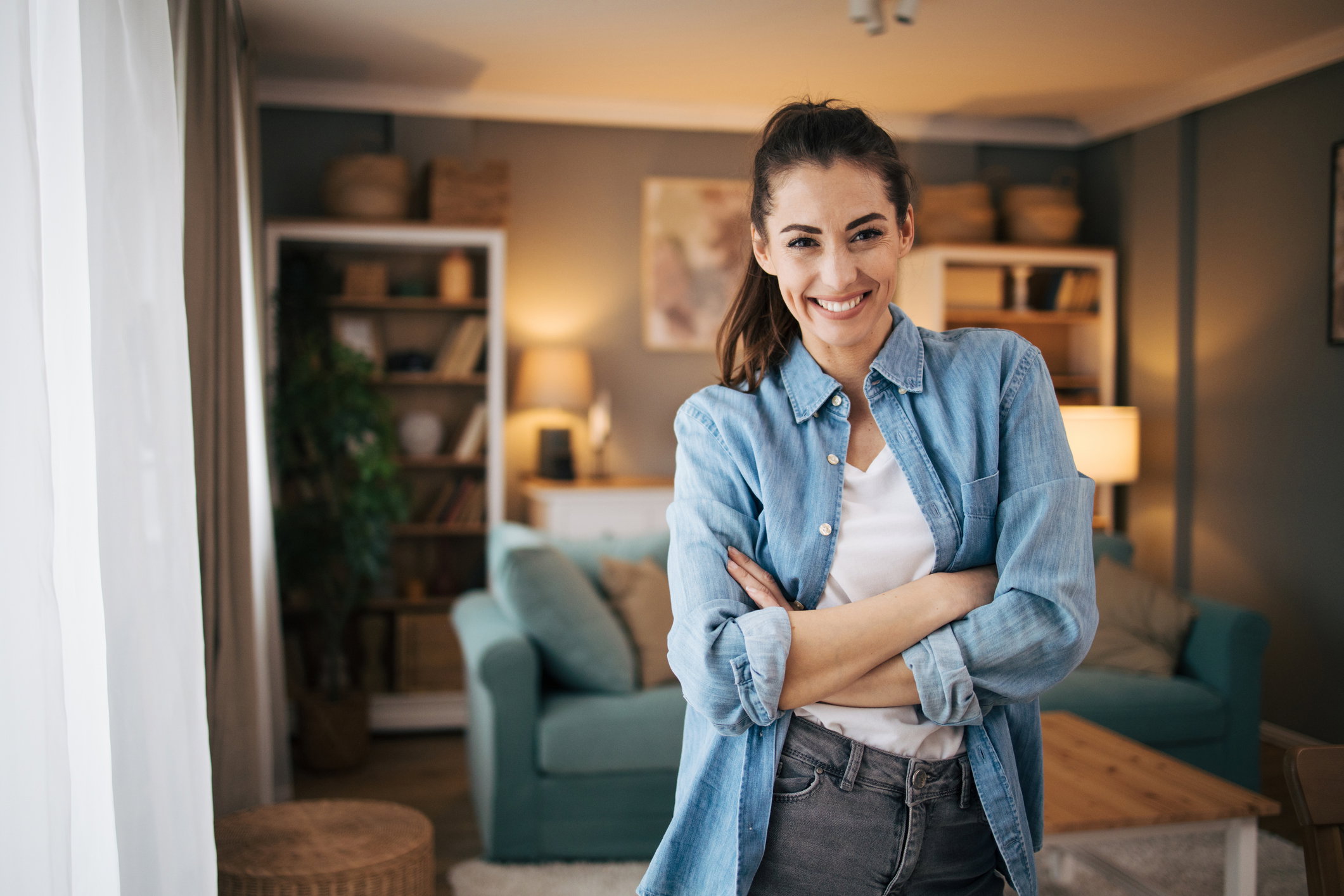 Portrait of smiling mid adult woman with arms crossed