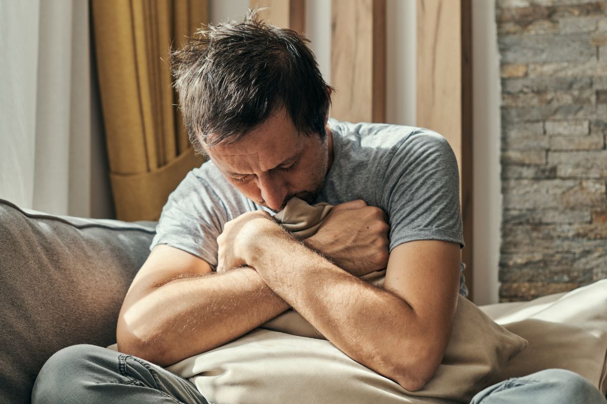 załamany mężczyzna z poduszką