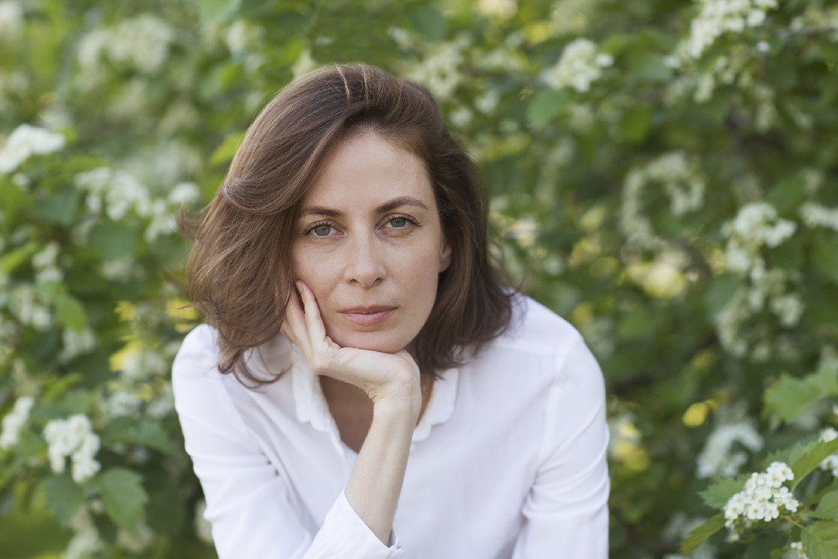 middle aged woman relaxed outdoors. copy space. Slow life. Enjoying the little things. spends time in nature in summer