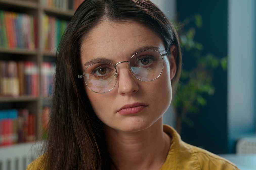 Sad worried tired exhausted girl Caucasian woman high school student teacher helpless stressful books studying learning college university library problem overwork holding text help education overload