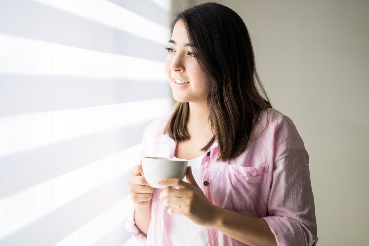 uśmiechnięta kobieta przy oknie