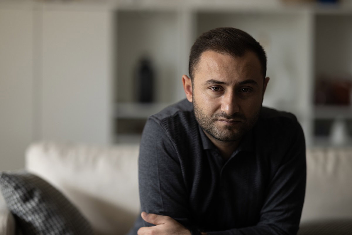Man sitting alone at home looking sad and distraught