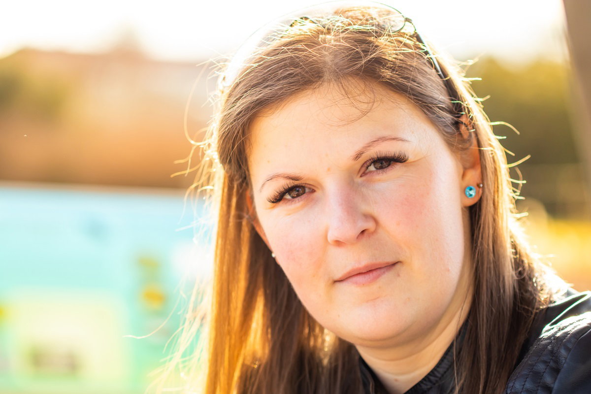 młoda dziewczyna z długimi włosami patrzy przed siebie z dumą w oczach