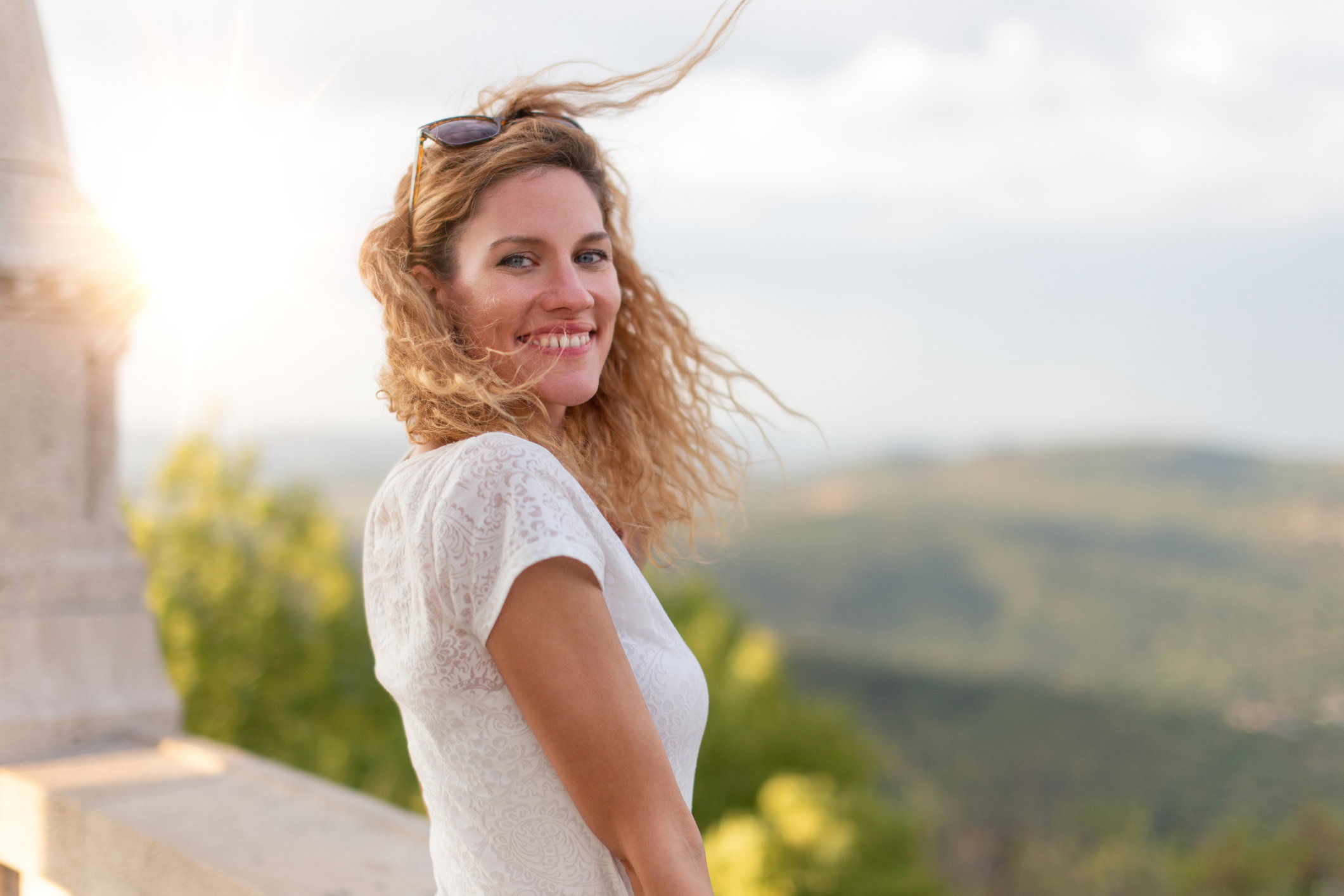 Happy young Caucasian woman toothy smile in outdoor sunset