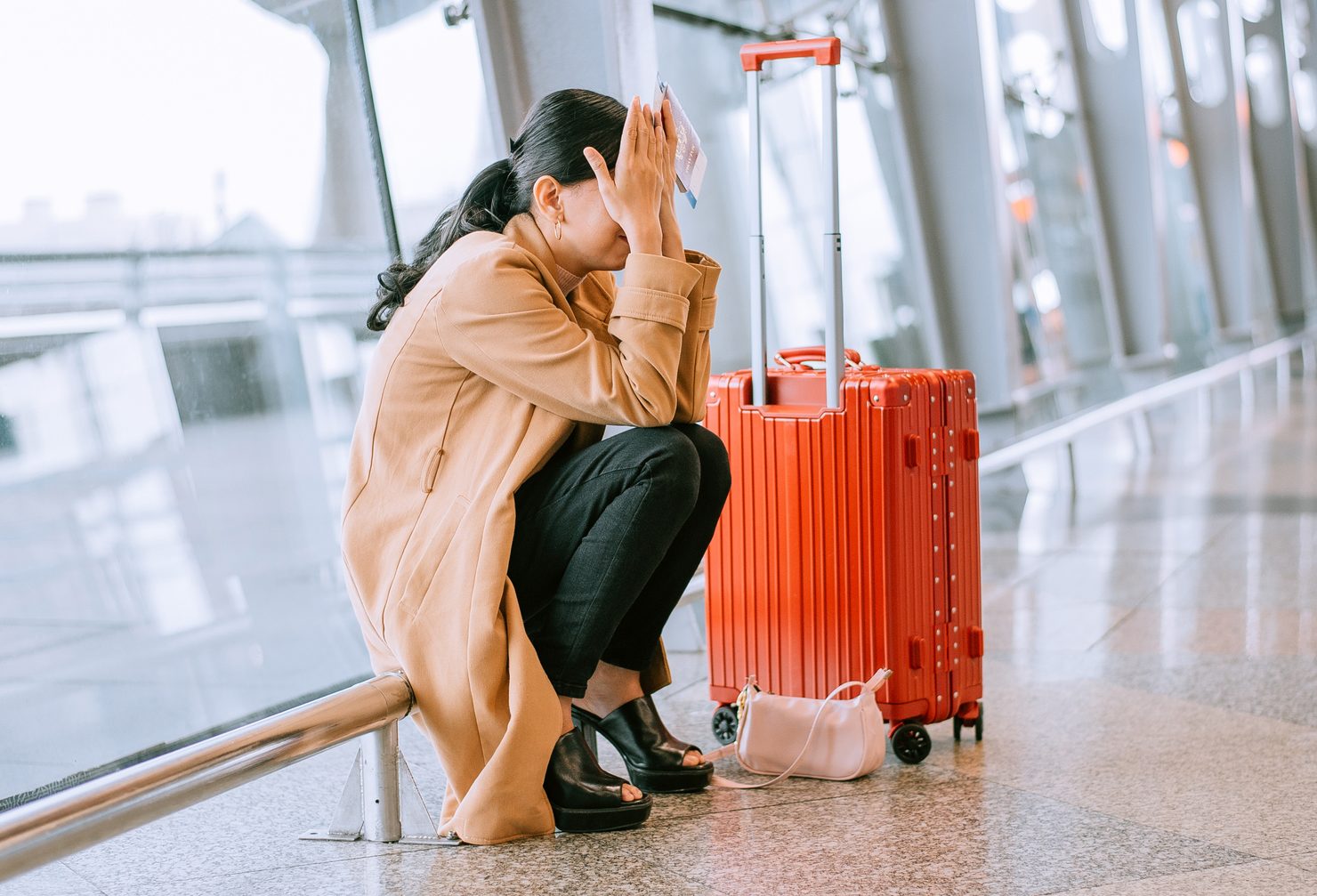 Young Asian woman upset and frustrated while flight canceled at the airport