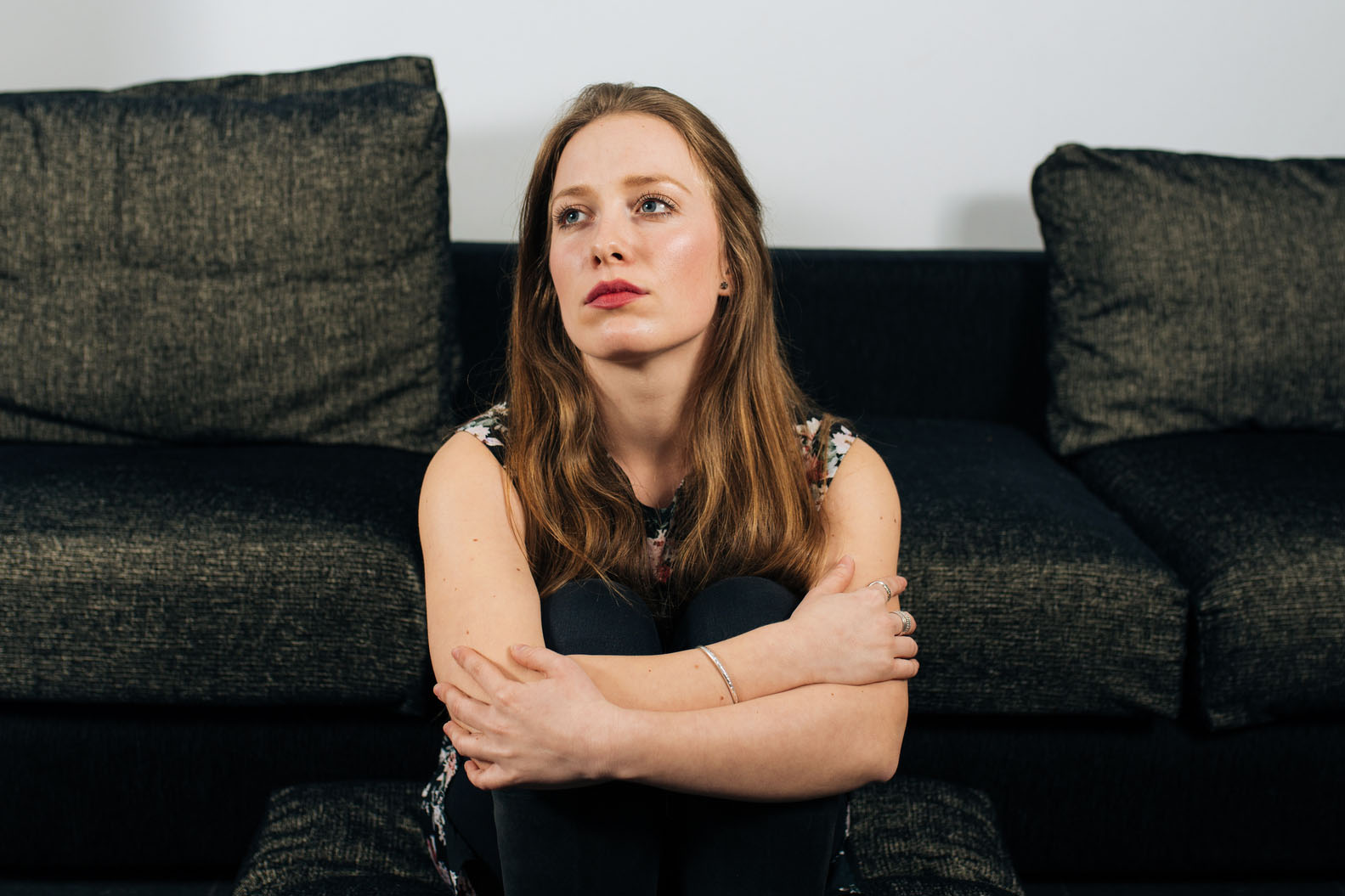 Alone and anxious young woman at home