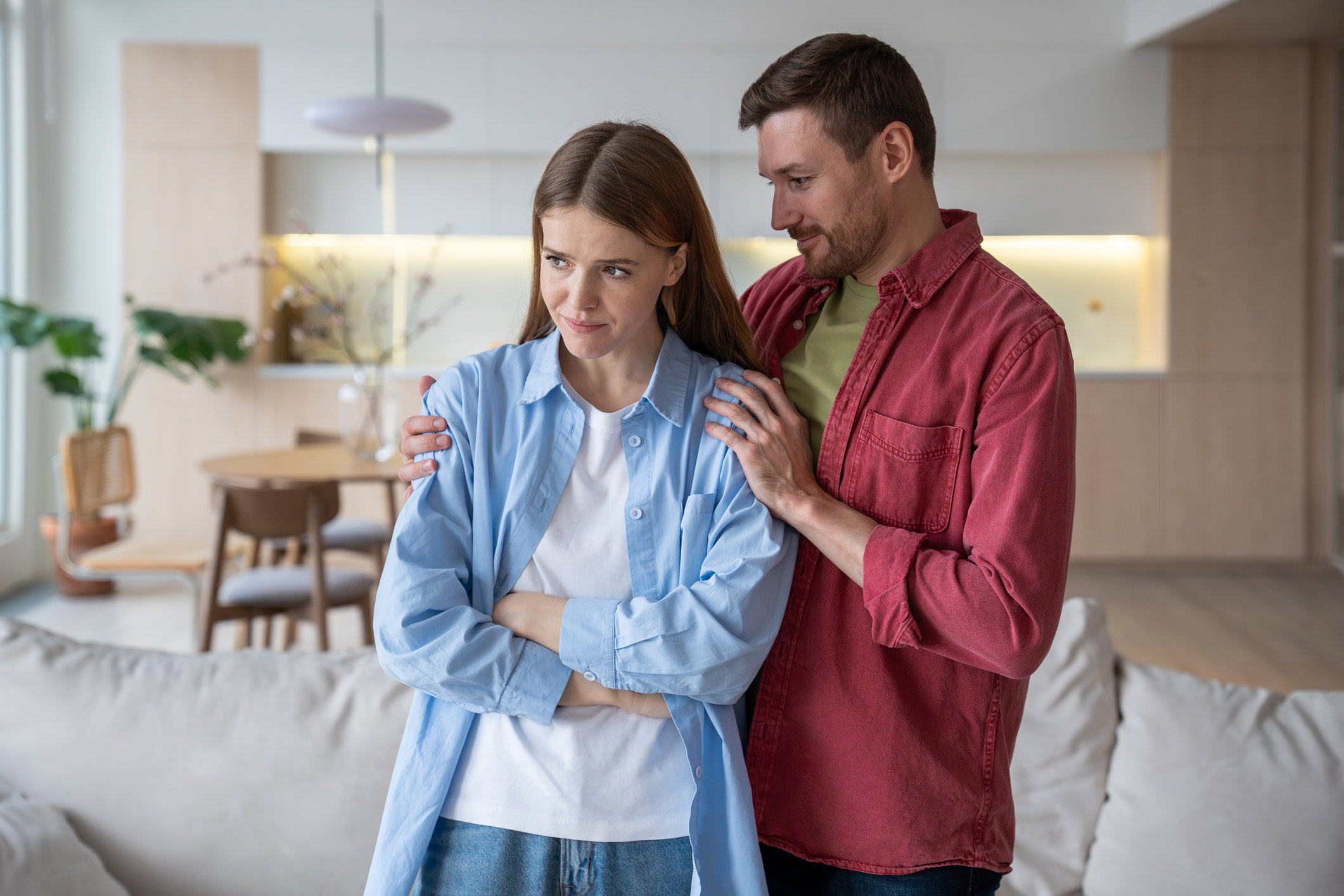Guilty boyfriend apologizes and sincerely repents, hugging woman to melt away beloveds resentment.