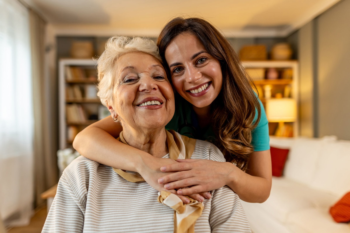 Cheerful Elderly Woman Embraced by a Loving Family Member at Home